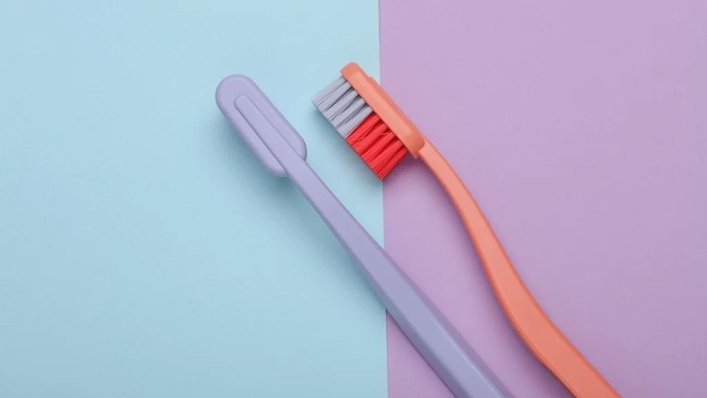a pair of toothbrushes on a purple and blue background